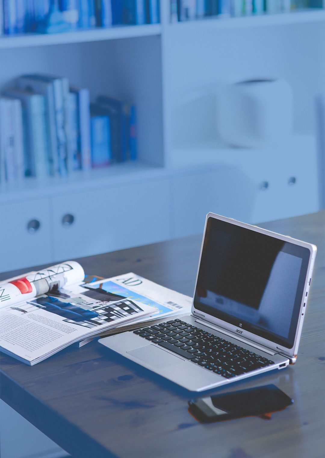 Workspace with a laptop and business magazines